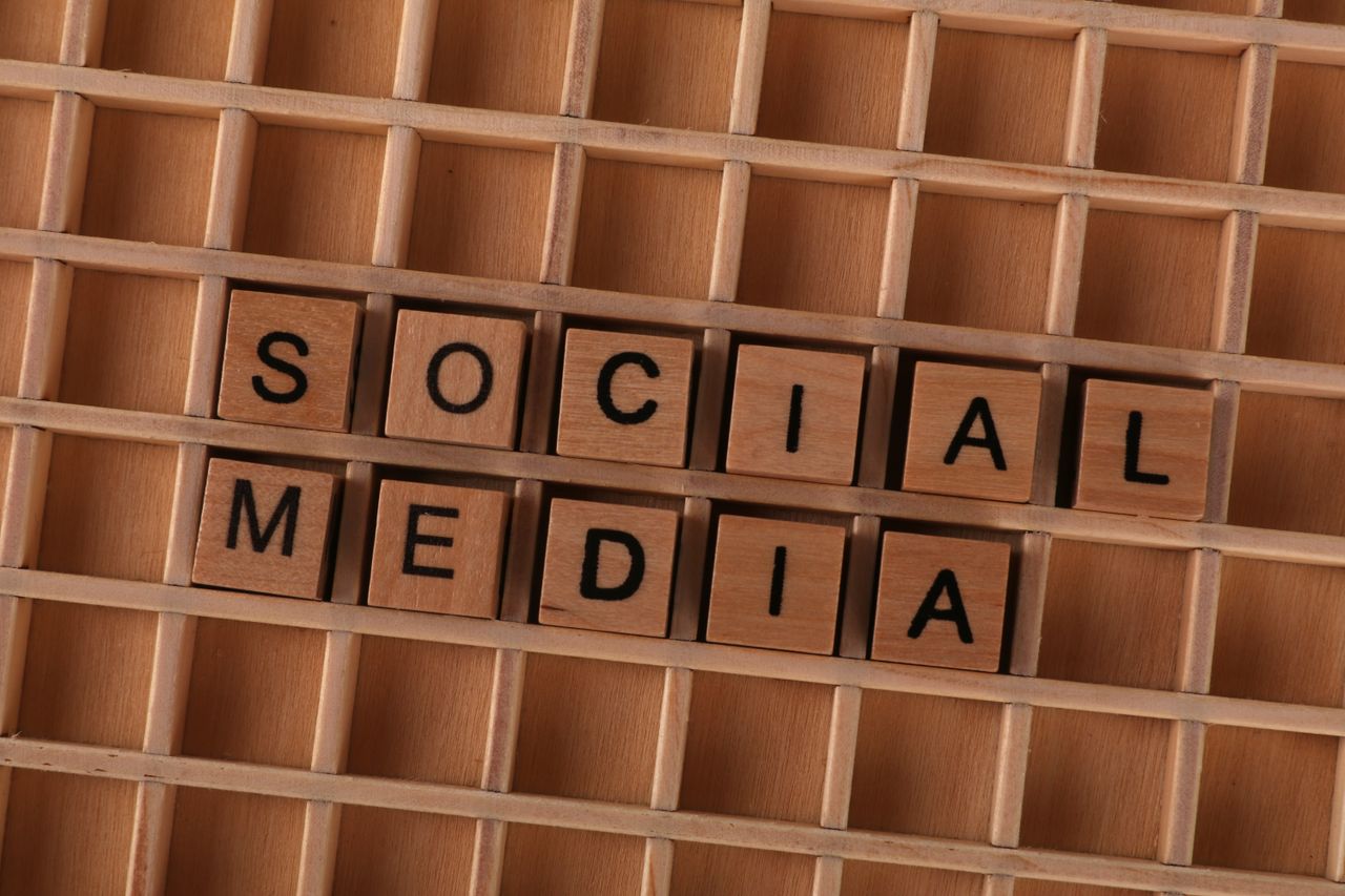 missions Close-up of wooden letter blocks spelling 'Social Media' on a wooden grid.